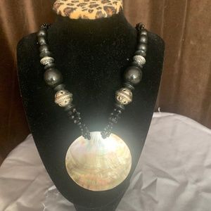 Black bead necklace with shell pendant
